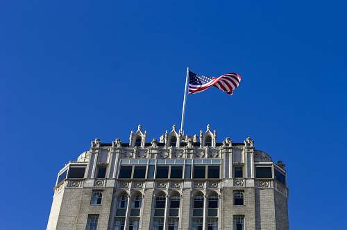 flag USA flag on pole on top of building symbol